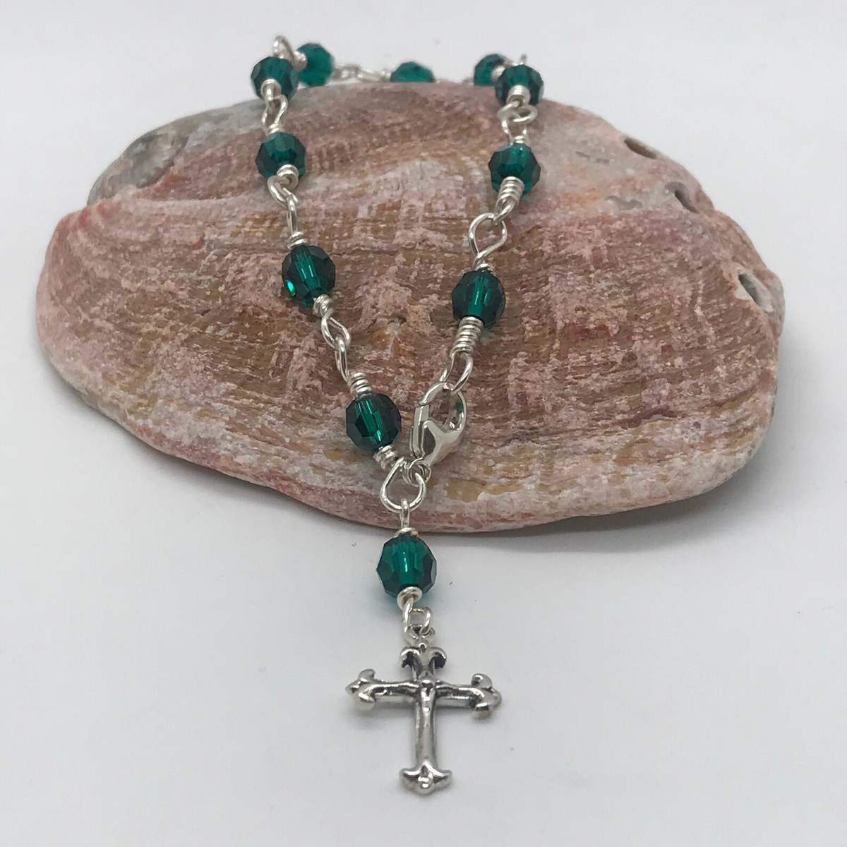 Emerald green crystal one-decade rosary bracelet with cross charm on pink stone