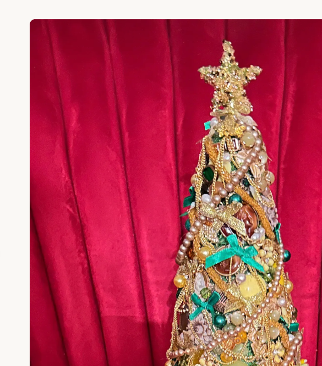 Green and gold vintage jewelry Christmas tree with decorative star topper
