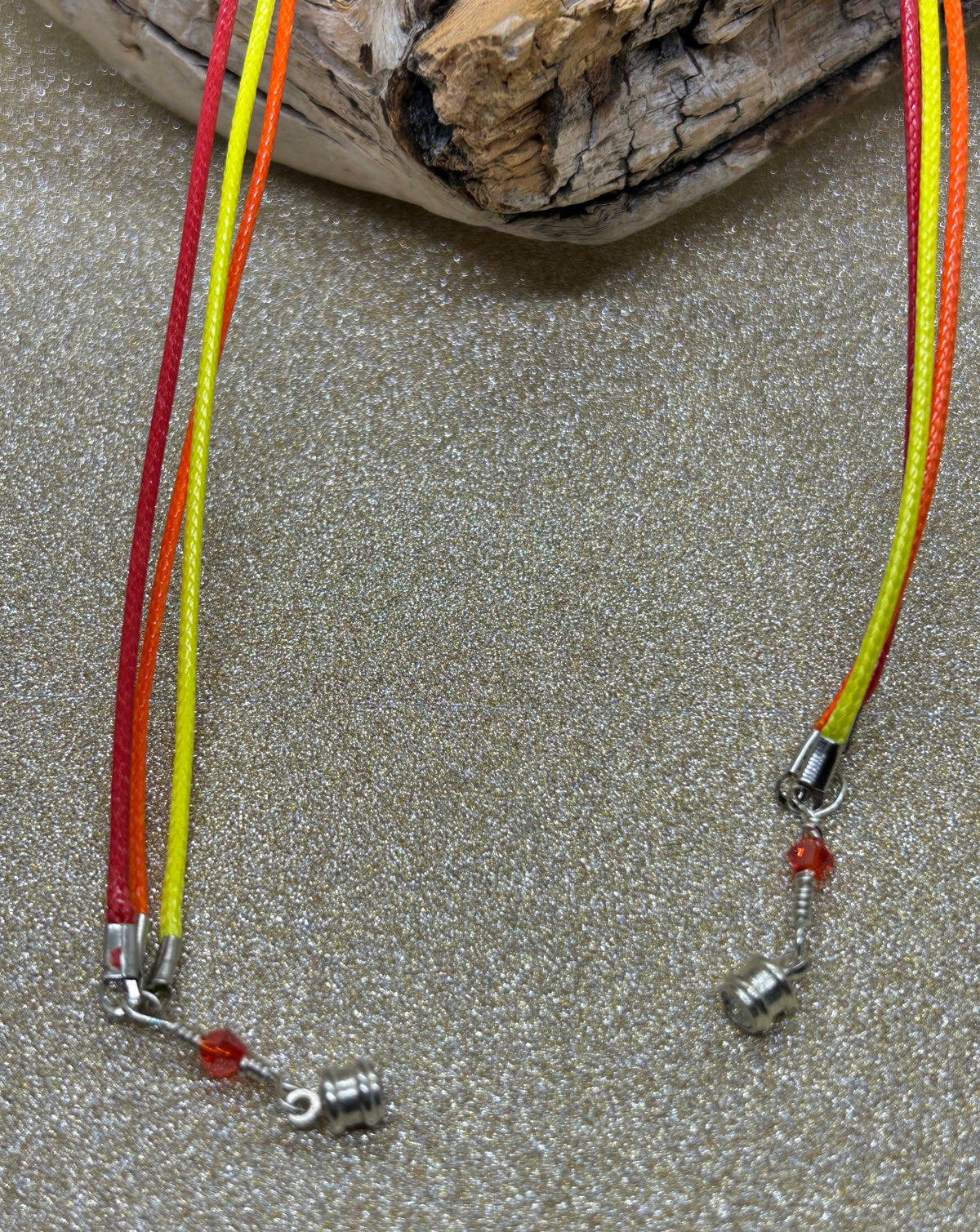 Silver magnetic clasp and red orange yellow cords