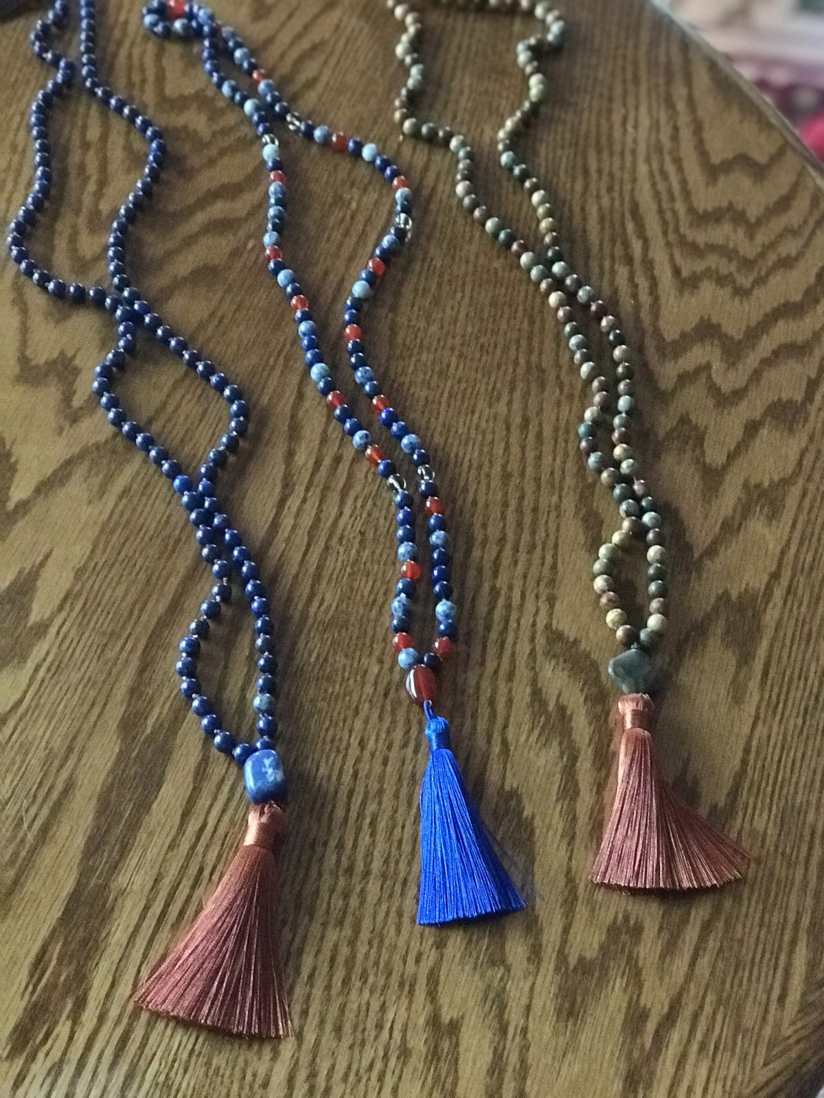 Example malas in lapis and green stones with copper and blue tassels
