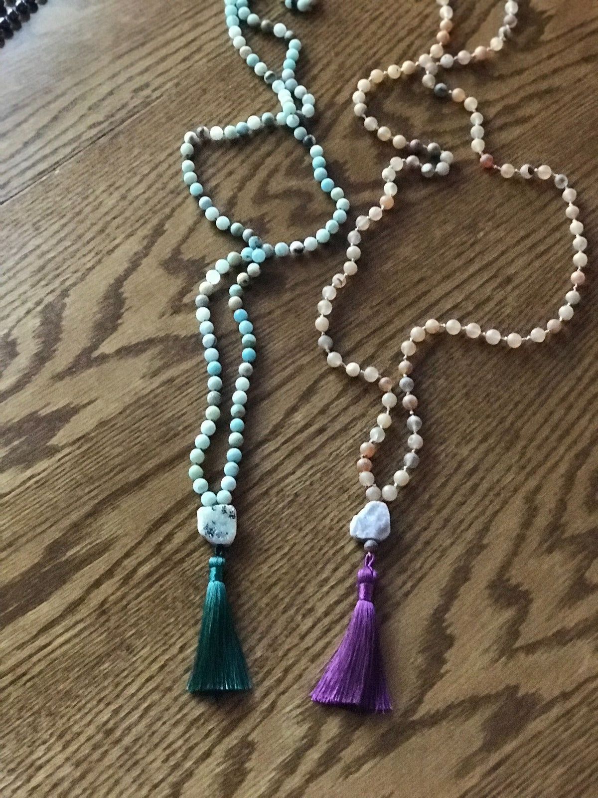 Example malas in green and peach stones with green and purple tassels
