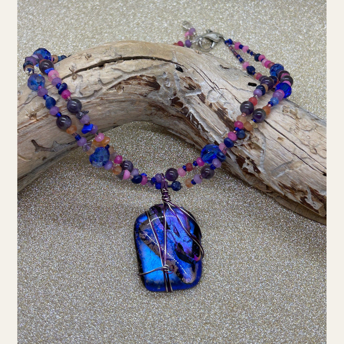 Electric blue and violet handmade dichroic glass necklace, photograph 1